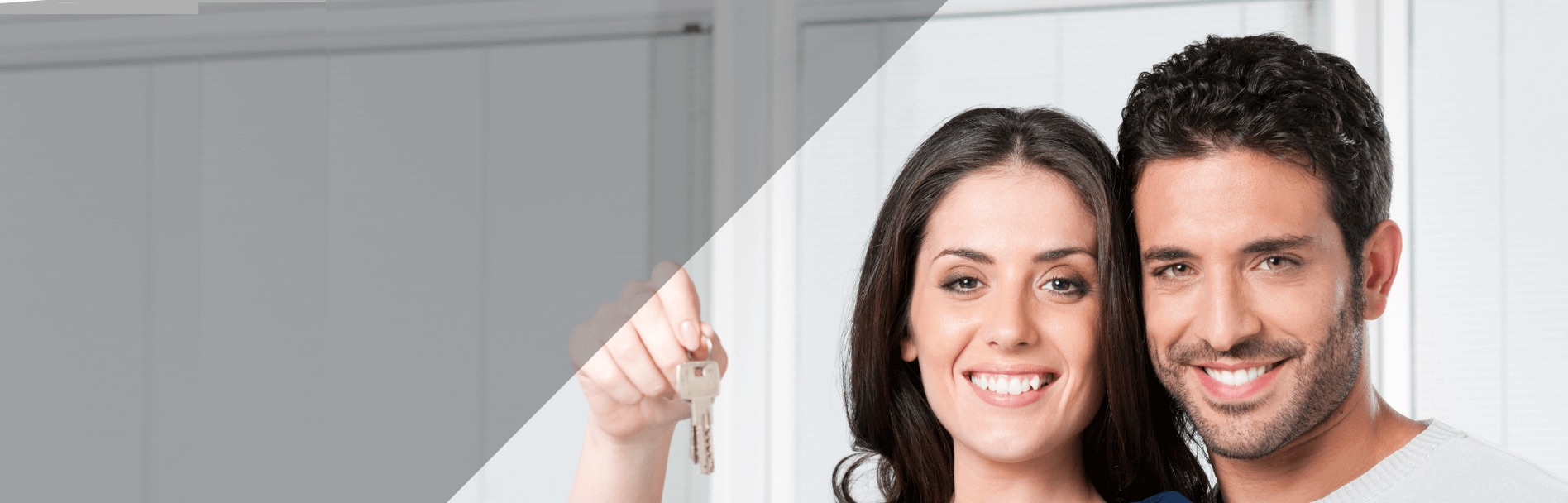 Couple holding new house keys after improving their credit with Evolve Credit Repair